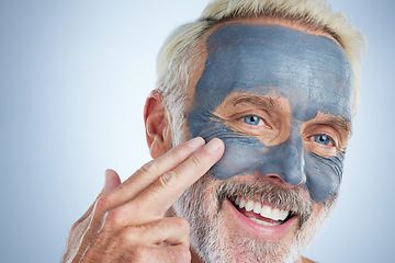 Image showing Senior man, skin and face mask in studio for health, wellness and organic cleaning with smile by background. Elderly male, hand and natural charcoal product for facial cosmetics for dermatology detox