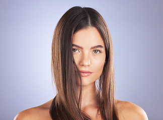 Image showing Beauty, woman and hair care portrait in studio for texture, growth and healthy shine on blue background. Aesthetic female model serious about haircare, and cosmetic for salon or hairdresser results