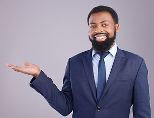 Image showing Portrait, black man and product placement for business in studio isolated on a gray background. Marketing, mockup and smile of happy African professional with branding, advertising or mock up space.