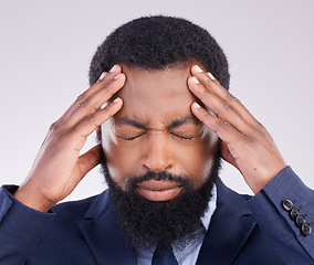 Image showing Business, headache and black man in studio of anxiety, debt and frustrated for stock market crash. Corporate male, face and stress in pain, burnout and bankruptcy of financial crisis, risk or problem