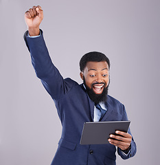 Image showing Winner black man on tablet isolated on gray background for stock market, trading and business bonus, fist pump and success. Yes, wow and power of person with winning news or digital profit in studio