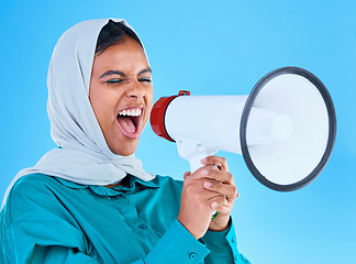 Image showing Young woman, muslim and loudspeaker in studio for protest, human rights and scream by blue background. Girl, islam and megaphone for speech, justice and vote for freedom, mission and power politics