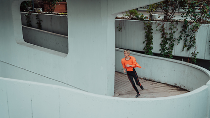 Image showing Women in sports clothes running in a modern urban environment. The concept of a sporty and healthy lifestyle