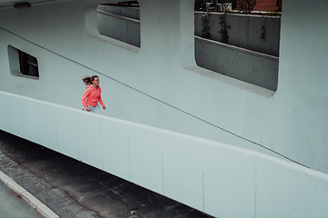 Image showing Women in sports clothes running in a modern urban environment. The concept of a sporty and healthy lifestyle