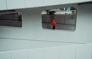 Image showing Women in sports clothes running in a modern urban environment. The concept of a sporty and healthy lifestyle