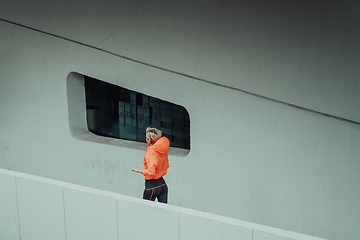 Image showing Women in sports clothes running in a modern urban environment. The concept of a sporty and healthy lifestyle