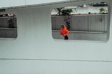 Image showing Women in sports clothes running in a modern urban environment. The concept of a sporty and healthy lifestyle