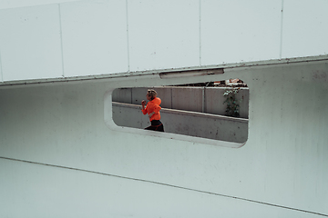 Image showing Women in sports clothes running in a modern urban environment. The concept of a sporty and healthy lifestyle