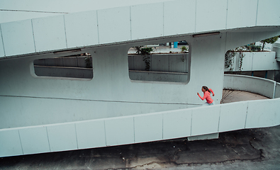 Image showing Women in sports clothes running in a modern urban environment. The concept of a sporty and healthy lifestyle