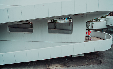 Image showing Women in sports clothes running in a modern urban environment. The concept of a sporty and healthy lifestyle