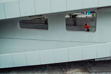 Image showing Women in sports clothes running in a modern urban environment. The concept of a sporty and healthy lifestyle