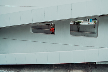 Image showing Women in sports clothes running in a modern urban environment. The concept of a sporty and healthy lifestyle