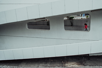 Image showing Women in sports clothes running in a modern urban environment. The concept of a sporty and healthy lifestyle