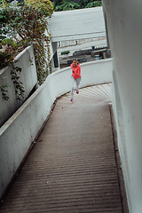 Image showing Women in sports clothes running in a modern urban environment. The concept of a sporty and healthy lifestyle