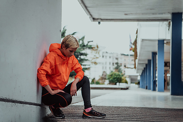 Image showing Young smiling female resting after an active fitness training