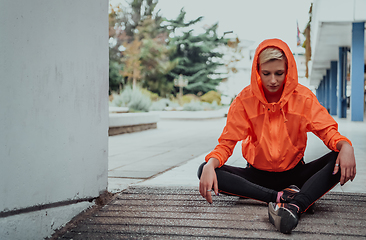 Image showing Two women in sports clothes running in a modern urban environment. The concept of a sporty and healthy lifestyle