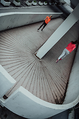 Image showing Two women in sports clothes running in a modern urban environment. The concept of a sporty and healthy lifestyle