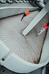 Image showing Two women in sports clothes running in a modern urban environment. The concept of a sporty and healthy lifestyle