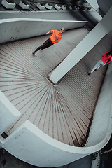 Image showing Two women in sports clothes running in a modern urban environment. The concept of a sporty and healthy lifestyle