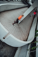 Image showing Two women in sports clothes running in a modern urban environment. The concept of a sporty and healthy lifestyle