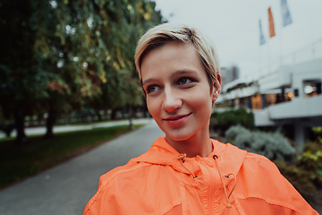 Image showing A blonde in a sports outfit is running around the city in an urban environment. The hot blonde maintains a healthy lifestyle.