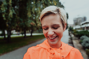 Image showing A blonde in a sports outfit is running around the city in an urban environment. The hot blonde maintains a healthy lifestyle.