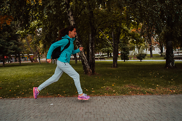 Image showing Women in sports clothes running in a modern urban environment. The concept of a sporty and healthy lifestyle