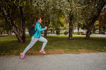 Image showing Women in sports clothes running in a modern urban environment. The concept of a sporty and healthy lifestyle