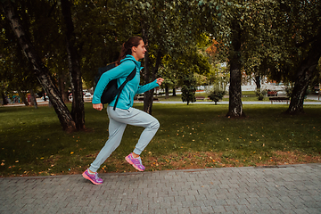 Image showing Women in sports clothes running in a modern urban environment. The concept of a sporty and healthy lifestyle