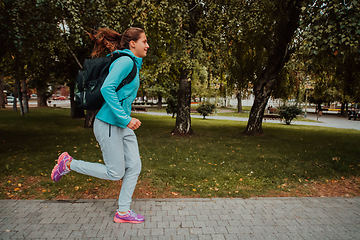 Image showing Women in sports clothes running in a modern urban environment. The concept of a sporty and healthy lifestyle