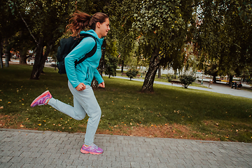 Image showing Women in sports clothes running in a modern urban environment. The concept of a sporty and healthy lifestyle