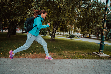 Image showing Women in sports clothes running in a modern urban environment. The concept of a sporty and healthy lifestyle