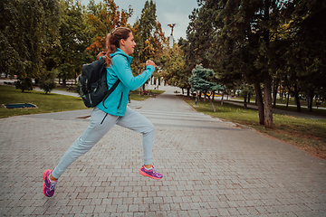 Image showing Women in sports clothes running in a modern urban environment. The concept of a sporty and healthy lifestyle