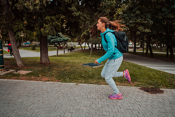 Image showing Women in sports clothes running in a modern urban environment. The concept of a sporty and healthy lifestyle