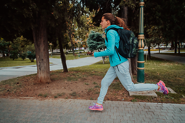 Image showing Women in sports clothes running in a modern urban environment. The concept of a sporty and healthy lifestyle