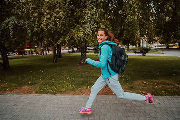 Image showing Women in sports clothes running in a modern urban environment. The concept of a sporty and healthy lifestyle