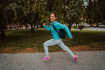 Image showing Women in sports clothes running in a modern urban environment. The concept of a sporty and healthy lifestyle