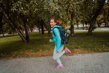 Image showing Women in sports clothes running in a modern urban environment. The concept of a sporty and healthy lifestyle