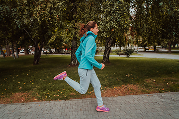 Image showing Women in sports clothes running in a modern urban environment. The concept of a sporty and healthy lifestyle