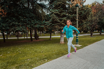 Image showing Women in sports clothes running in a modern urban environment. The concept of a sporty and healthy lifestyle