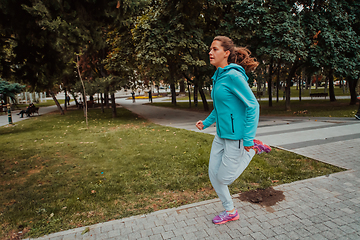 Image showing Women in sports clothes running in a modern urban environment. The concept of a sporty and healthy lifestyle