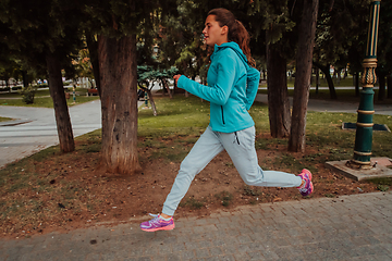 Image showing Women in sports clothes running in a modern urban environment. The concept of a sporty and healthy lifestyle