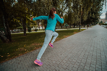 Image showing Women in sports clothes running in a modern urban environment. The concept of a sporty and healthy lifestyle