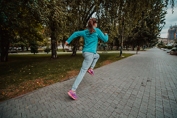 Image showing Women in sports clothes running in a modern urban environment. The concept of a sporty and healthy lifestyle