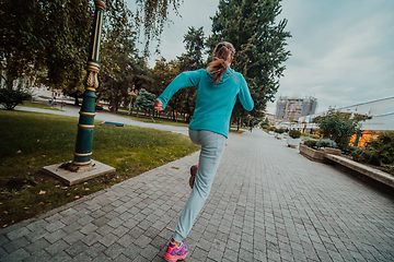 Image showing Women in sports clothes running in a modern urban environment. The concept of a sporty and healthy lifestyle