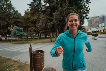 Image showing Women in sports clothes running in a modern urban environment. The concept of a sporty and healthy lifestyle