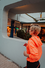 Image showing Women in sports clothes running in a modern urban environment. The concept of a sporty and healthy lifestyle