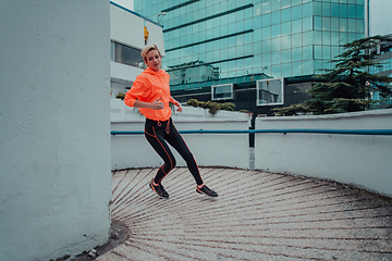 Image showing Women in sports clothes running in a modern urban environment. The concept of a sporty and healthy lifestyle