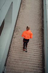 Image showing Top view photo of omen in sports clothes running in a modern urban environment. The concept of a sporty and healthy lifestyle