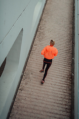 Image showing Top view photo of omen in sports clothes running in a modern urban environment. The concept of a sporty and healthy lifestyle